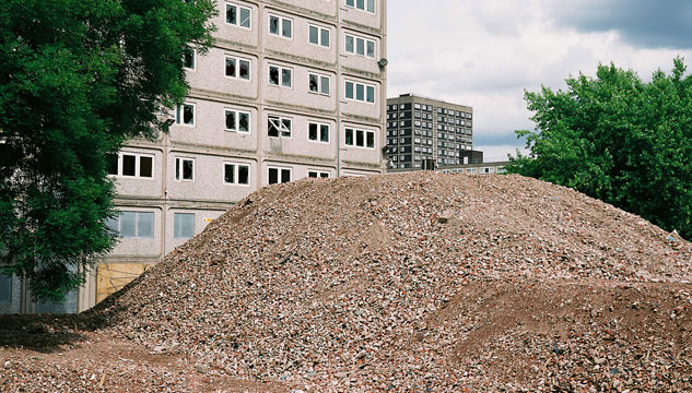 A mound of gravel outside a tower block