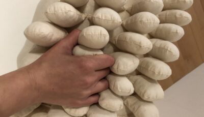 hand squeezing white oval objects