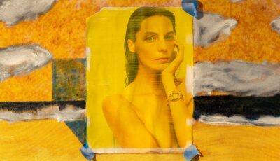 A yellow collage image of a woman from an advertisement over an abstract painted surface.