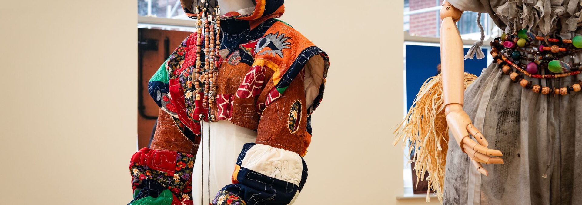 A mannerquin featuring a patchwork cropped jacket with baggy sleaves