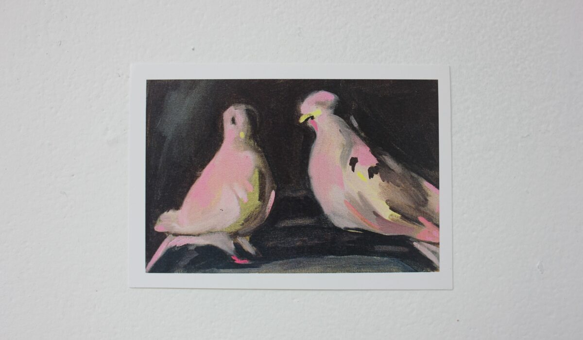 Postcard with design of two pigeons against black background.