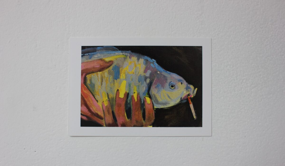 Postcard of a fish with a cigarette in its mouth, set against a black background.
