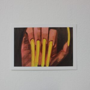 Postcard of a hand with long, yellow acrylic nails, set against a black background.