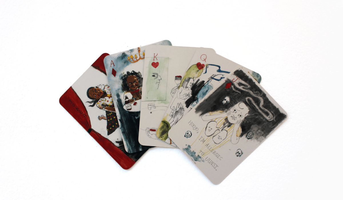 Five playing cards spread out showing design details.